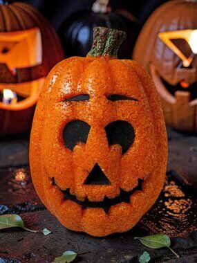 Vintage "Seasons" brand jack-o'-lantern is crafted from orange melted plastic po